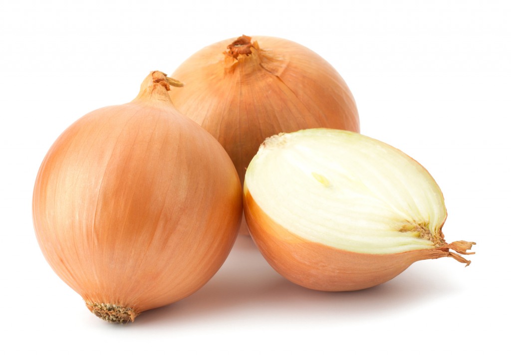 Fresh bulbs of onion on a white background